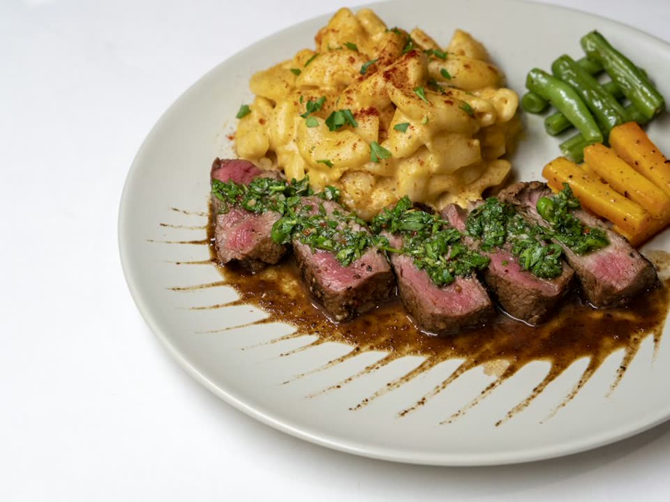 Chimichurri flank steak, sliced and plated