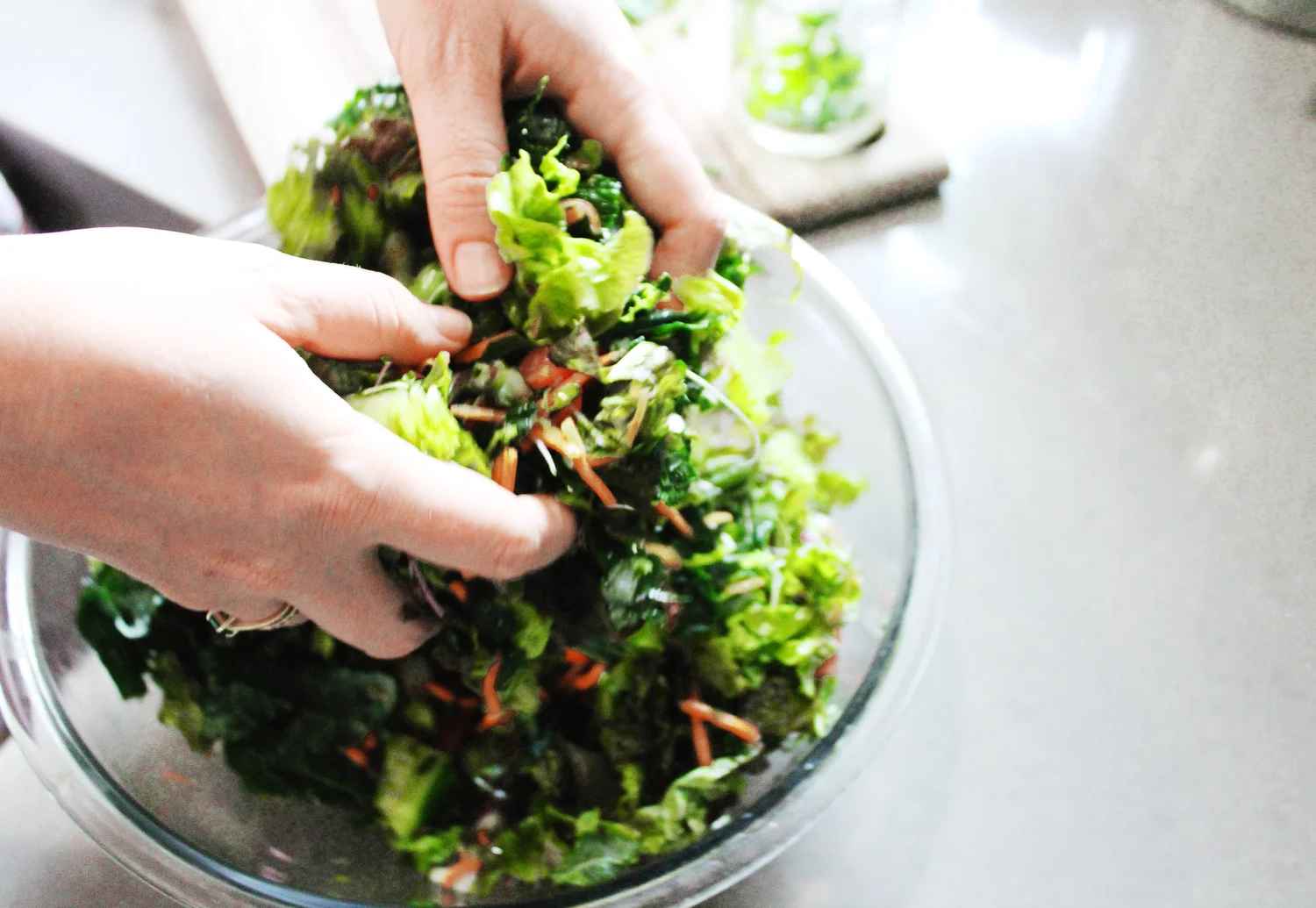 Tossing kale salad