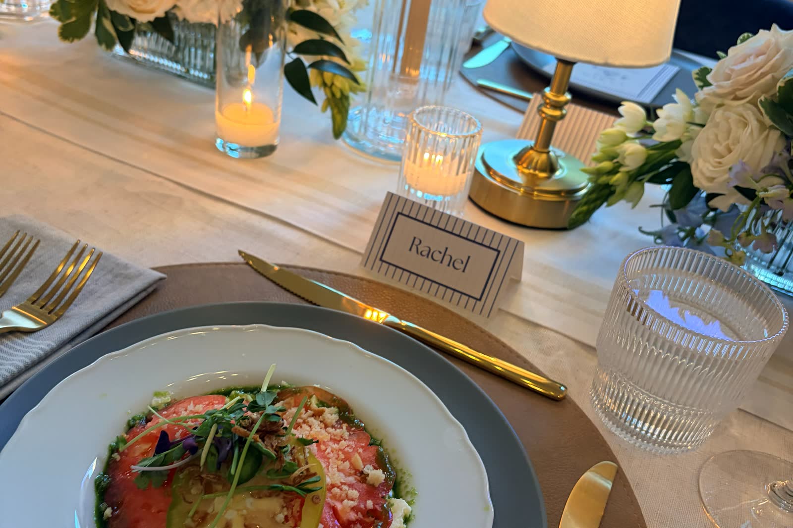 An intimate dinner place setting with a plated first course